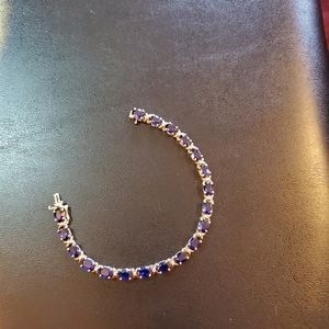 A sterling silver bracelet with blue stones